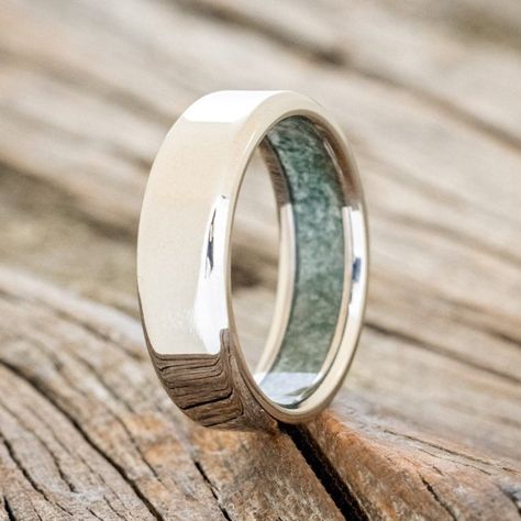 Product Details Ring Style: A custom, handcrafted men's wedding ring featuring a unique crushed moss agate lining. Additional inlay options are available upon request. Width: The width of the ring pictured is 6mm, but can be ordered in a custom width accompanied by a design change fee. Please state your desired width in the Custom Requests section during checkout, and we will reach out to you for payment. Customizable: Because each ring is handcrafted to order, we can customize yours using uniqu Boho Wedding Bands, Mens Silver Wedding Bands, Green Engagement Rings, Agate Wedding Ring, Agate Wedding, Simple Rings, Staghead Designs, Men's Wedding Ring, Ring Ideas