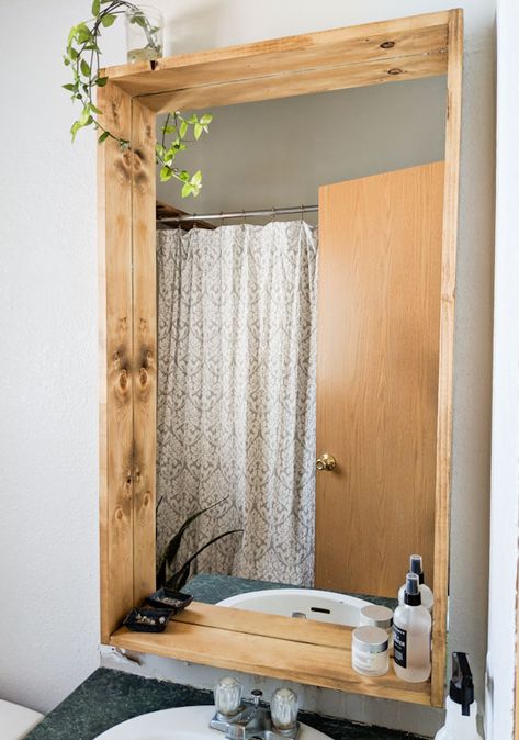 Bring some added character to your bathroom with a DIY bathroom mirror makeover. This easy tutorial guides you in adding a rustic DIY wooden bathroom mirror frame. Diy Bathroom Mirror Makeover, Diy Bathroom Mirror, Wooden Bathroom Mirror, Bathroom Renovation Diy, Bathroom Mirror Makeover, Bathroom Mirrors Diy, Diy Bathroom Makeover, Bathroom Mirror Frame, Mirror Makeover