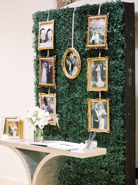 Gold-framed, black and white photos make up this couple's family tree on a wall of green. Guests can sign and leave notes for the newlyweds below in the guestbook. Wedding by Bello & Blue Events. Green And Gold Wedding Ceremony, Gold And Hunter Green Wedding, Emerald Green Gold And White Wedding Decorations, Emerald Green Black Gold Wedding, Emerald Gold White Wedding, Gold Frames Wedding, Emerald And Gold Party Decor, Green Wall Wedding, Family Table Wedding