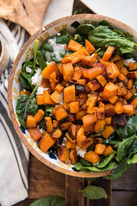 A warm spinach salad that's perfect for entertaining! This warm spinach salad recipe is chock full of healthy greens tossed in warm goat cheese and roasted butternut squash with your favorite salad dressing. Glazed pecans add a little sweetness. A perfect spring salad to bridge the gap between winter comfort food and healthy spring eats. #spinachsalad #warmgoatcheese Spinach Pecan Salad, Spinach Butternut Squash Salad, Brussel Sprout Butternut Squash Goat Cheese, Roasted Butternut Squash Brussel Sprouts Goat Cheese, Roasted Butternut Squash Salad Recipes, Salad With Butternut Squash Goat Cheese, Spinach Goat Cheese Salad, Butternut Squash Spinach, Wilted Spinach