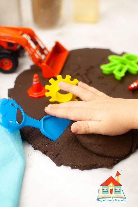 Unleash a world of fun and learning with this easy chocolate playdough recipe! Preschoolers will love the yummy scent and squishy texture as they strengthen their fine motor skills. This sensory dough ignites imaginations, perfect for baking pretend cookies or crafting a chocolate garden. Find the full recipe and explore tons of themed play ideas on our website! #preschool #playdough #sensoryplay Hot Chocolate Playdough Recipe, Chocolate Playdough Recipe, Chocolate Playdough, Preschool Playdough, Sensory Dough, Playdough Recipe, Homemade Playdough, Play Ideas, Easy Chocolate