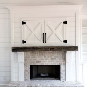 Farmhouse Style Fireplace | Doors To Hide TV Dost Photo, Hide Tv Over Fireplace, Farmhouse Style Fireplace, Unfinished Basement Laundry, Fireplace Farmhouse, Farmhouse Fireplace Ideas, Rustic Farmhouse Fireplace, Hide Tv, The Lettered Cottage