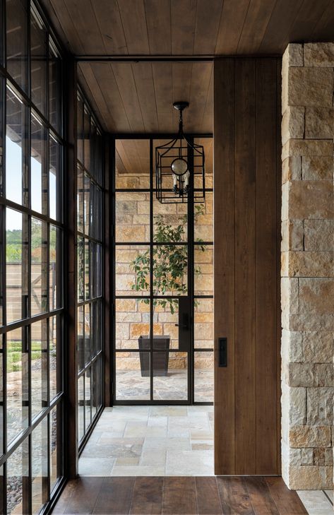 Floor-to-ceiling steel windows by Rehme Steel Windows & Doors appear in the primary hallway. They provide a clean counterpoint to dry-stacked Texas limestone walls, stone floors and stained Douglas fir ceilings. French Doors With Transom, Pintu Interior, Steel French Doors, Steel Doors And Windows, Industrial Door, Doors Ideas, Swedish Decor, French Doors Exterior, Double French Doors