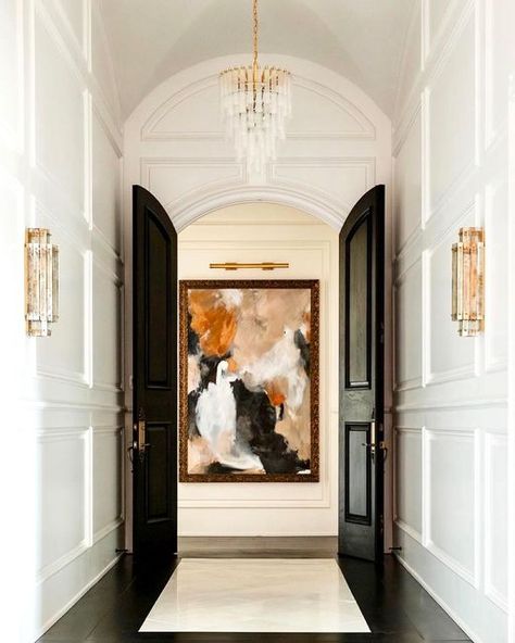 Julie Neill on Instagram: "Every detail in this gorgeous space designed by @lanie_k_interiors comes together to create a space that feels harmonious with a splash of drama! The high ceilings, beautiful archway, grand doors create a feel of luxurious serenity while bold art and glamorous light fixtures make the space anything but boring. Definitely white done right 👌🏻. We love seeing our Lorelei Chandelier in the mix in this fabulous space 😍. Builder: @clearviewcustomhomes 📷 @marciemeredith # Classic Wall Lights, Waterfall Chandelier, Entry Design, Statement Chandeliers, Small Waterfall, Bold Art, High Ceilings, Beautiful Lighting, Custom Door