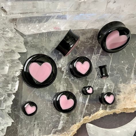 "WELCOME TO PINK ALIEN BABE  YOUR ONE STOP SHOP FOR ALL THE CUTEST PLUGS AND ACCESSORIES IN THE GALAXY 🪐⭐️ 🎀This is a listing for A PAIR (two pieces) of Aphrodite Inner Love ear plugs, black acrylic double flared gauges with baby pink hearts inside of them in your choice of size.  👽💕 Sizes available: 2g 6mm, 0g 8mm, 00g 10mm, 1/2\" 12mm, 9/16\" 14mm, 5/8\" 16mm, 11/16\" 18mm, 3/4\" 20mm, 7/8\" 22mm, 1\" 25mm, 28mm, 30mm, 32mm, 34mm, 36mm, 38mm, 40mm, 42mm, 44mm, 46mm, 48mm, 2\" 50mm 👽💕 Loo 8 Gauge Ears, 12 Mm Gauges, Eat Gauges, Heart Gauges Plugs, Cute Gauges Plugs, Cute Ear Gauges, Double Gauged Ears, 00 Gauges In Ear, 0g Stretched Ears