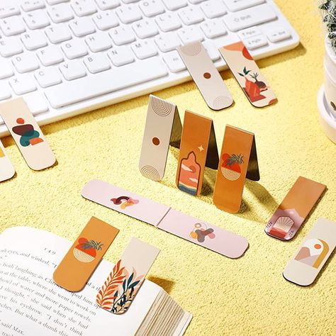 Discover the perfect blend of beauty and function with these magnetic bookmarks! These artistic creations are designed to mark your place in style, featuring vibrant colors and intricate designs that will add a touch of elegance to any book. With their strong magnets and durable materials, they'll keep your page secure while adding a unique and personal touch to your reading experience. #magneticbookmarks #artisticbookmarks #booklovers #reading #bookmarklove Craft Fair Display Table, Plant Bookmark, Home Office Supplies, Magnetic Book, Page Markers, Bookmark Craft, Craft Fair Displays, Book Markers, Magnetic Bookmarks