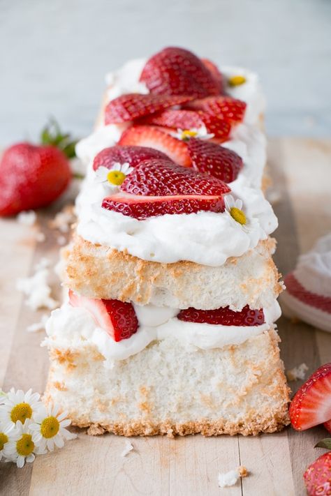 Light, fluffy, and sweet Strawberry Angel Food Cake. Put the season's sweet and tasty strawberries to sweet use in this strawberry dessert recipe. Angel Food Cake Layer Cake, Angel Cake With Strawberries, Angel Food Wedding Cake Ideas, Angel Food Cake In Loaf Pan, Fancy Angel Food Cake, Angel Food Cake Recipes Loaf Pan, Angel Food Cake Loaf Pan, Angel Food Sheet Cake, Strawberries And Angel Food Cake