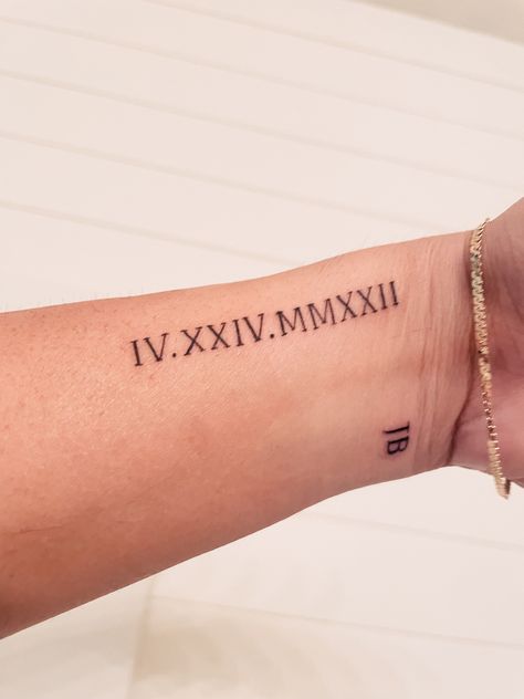 Roman Numeral Script Tattoo, Years In Roman Numerals Tattoo, Roman Script Tattoo, Wrist Tattoos For Women Roman Numerals, Side Wrist Tattoos Roman Numerals, Roman Numeral Placement Tattoo, Anniversary Roman Numeral Tattoo, Roman Numeral Sibling Tattoo, Minimalist Roman Numeral Tattoo