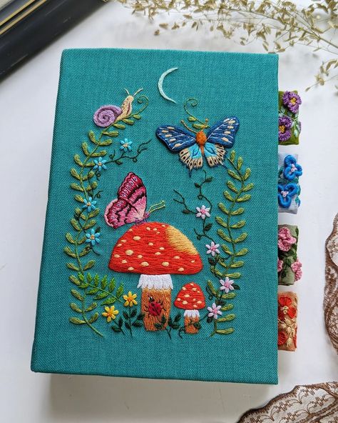 It's always a challenge to fit my embroidery into the book cover, but I'm happy with how it turns out. 🪡🍄 #handembroidery #artjournal… | Instagram Hand Embroidered Book Cover, Embroidery Book Cover Ideas, Embroidery On Book Cover, Embroidery Book Cover, Journal Covers Diy, Book Embroidery, Vintage Core, Embroidered Book, Themed Journal