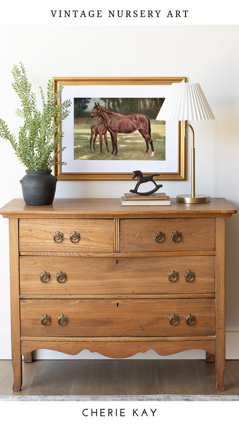 Vintage equestrian nursery art print featuring a mare and foal, elegantly framed in a classic gold frame, displayed above a rustic wooden dresser with farmhouse-inspired decor and subtle greenery. Vintage Horse Nursery, Horse Nursery Girl, Horse Themed Nursery, Vintage Hunting Nursery, Antique Baby Nursery, Equestrian Nursery, Vintage Cowboy Nursery, Vintage Girls Rooms, Hunting Nursery