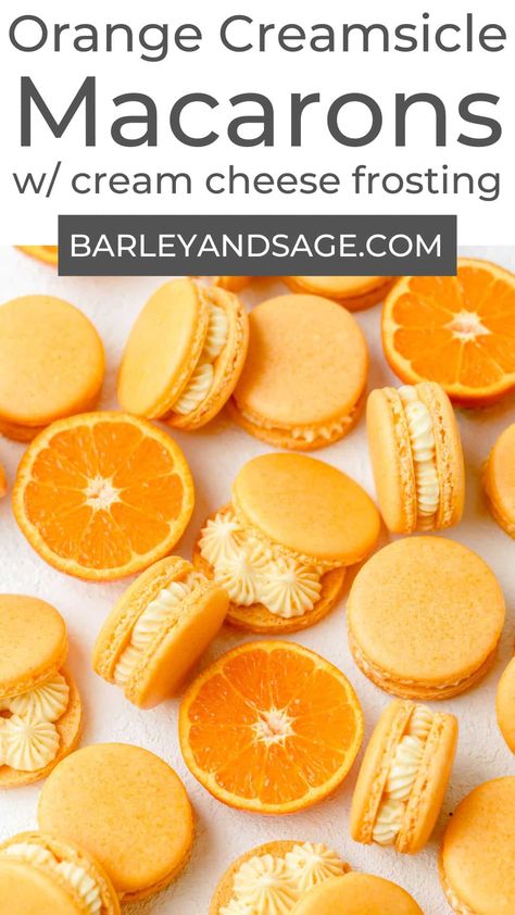 These orange creamsicle macarons have a light, orange flavored macaron shell filled with a vanilla cream cheese frosting. They taste just like a classic orange creamsicle but in macaron form! Orange Macarons Aesthetic, Orange And Blue Macarons, Spring Macarons Flavors, Orange Macarons Recipe, Fruity Macaron Flavors, Orange Cream Dessert, Orange Creamsicle Macaron, Orange Food Recipes, Orange Colored Desserts