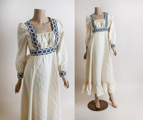 "FREE DOMESTIC SHIPPING! <3 ♥ Gorgeous vintage 1970s Gunne Sax prairie dress!  ♥ A nice off-white oatmeal color.  ♥ Nylon zipper in the back, along with attached apron style ties in the back!  ♥ Long sleeves with wooden button cuffs. Blue floral trims/cuffs!  ♥ Square neckline with elastic at the top, creating a gathered looking bust - very renaissance. Floor length maxi skirt with quilt panel in front and ruffle hem.  ♥ In great condition! There is a smaller stain on the skirt, and on the inner Gunne Sax Dress Vintage 70s, 1970s Style Fitted Prairie Dress With Long Sleeves, White Vintage Prairie Dress With Ruffles, 1970 Prairie Dress, Blue Gunne Sax Dress, 70s Prairie Dress, 1970s Long Sleeve Prairie Dress, Sax Dress, Prairie Dresses