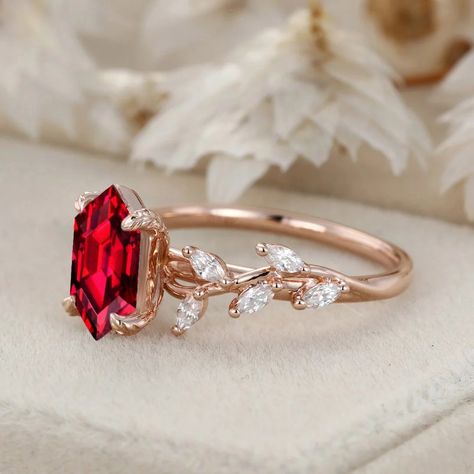 Our hexagon cut lab-grown ruby engagement ring in 14k solid gold seamlessly blends modern sophistication with the timeless beauty of nature. The vibrant lab-grown ruby adds a touch of charm to this elegant piece. Vintage Engagement Rings Ruby Red Stones, Vintage Ruby Wedding Rings, Burgundy Engagement Ring, Wedding Rings With Ruby, Engagement Rings With Rubies, Ruby Rose Ring, Ruby And Emerald Engagement Ring, Ruby Red Engagement Ring, Red Ruby Engagement Ring