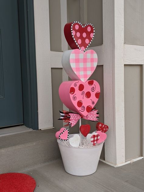 Hand painted and homemade whimsical topiaries. #valentinesday Valentine Door Swag Diy, Valentines Day Topiary Diy, Painted Valentine Hearts, Diy Valentines Decorations Outdoor, Valentine Topiary Diy, Valentines Topiary Diy, Outdoor Valentine Decor, Valentine’s Day Centerpiece Diy, Valentines Day Outdoor Decorations