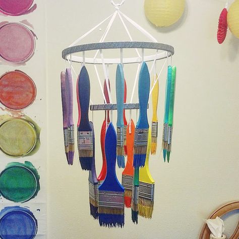 Paint Brush Chandelier for my art classroom! IG: @rainbow.art.teacher Paint Brush Chandelier, Classroom Ceiling, Daycare Rooms, Curiosity Approach, Artist Business, School Age, Rainbow Art, Toddler Room, Art Table