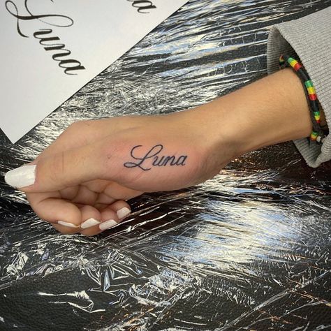 Thumb Word Tattoos, Name On Thumb Tattoo, Name Tattoos Cursive, Names On Hand Tattoos, Names In Cursive Tattoos, Name Tattoos Hand, Hand Tattoo Script, Hand Name Tattoos For Women, Hand Tattoo Name