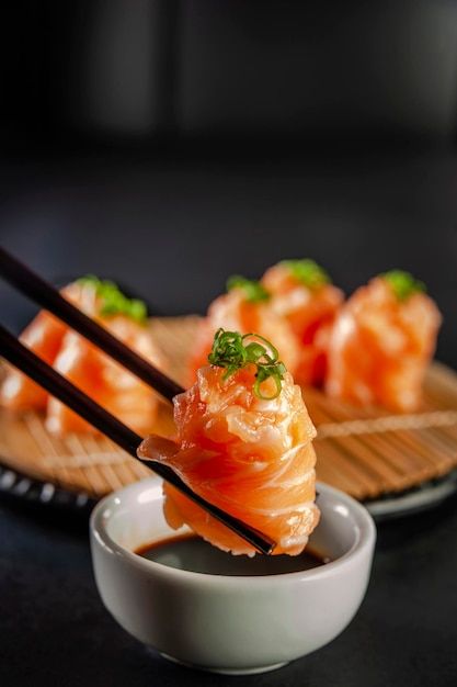 Photo salmon jhow sushi on chopsticks on... | Premium Photo #Freepik #photo #sashimi #salmon-sashimi #sushi-restaurant #sushi Foto Sushi, Japanese Food Photography, Sushi Rice Recipes, Salmon Sushi, Restaurant Photography, Best Sushi, Food Content, Food Drink Photography, Sushi Recipes