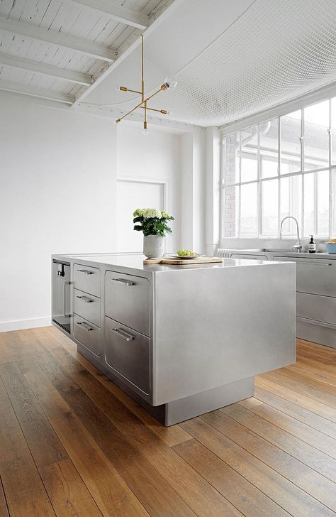 Base of the stainless steel kitchen island gives it a breezy appeal Steel Island Kitchen, Stainless Steel Kitchen Decor, Stainless Steel Kitchen Design, Vintage Industrial Kitchen, Paris Loft, Industrial Decor Kitchen, Stainless Steel Kitchen Island, Kitchen Loft, Industrial Kitchen Design