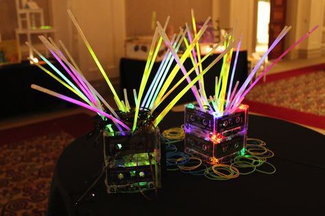 '80s gala centerpieces! We ripped apart old tape cassettes, stuffed them into these centerpieces with LED lights and put cheap glow sticks inside - looked amazing when lights were dim! 70s Party Decorations, Neon Party Decorations, Decades Party, Decade Party, 80s Party Decorations, 90s Birthday, 80s Wedding, 80s Birthday Parties, Glow Stick Party