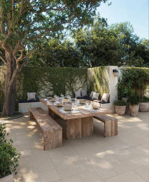 Gallery Craftsman Home Backyard, Hamptons Inspired Backyard, Plaster Garden Wall, White Stucco House Landscaping, Outside Wooden Table, Porcelain Tile Floor Outdoor, Patio Wall Color Ideas, Spanish Style Pavers, Mediterranean Pavers