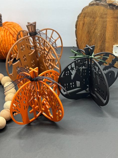 The centerpiece boasts intricate spooky trees, swooping bats, and a haunting graveyard scene. Whether as a bewitching table centerpiece or a haunting mantel display, our Laser-Cut 3D Pumpkin Laser Cut Christmas Tree, Laser Cut Halloween, Decorative Pumpkins, Laser Cut Christmas, 3d Pumpkin, Laser Cut Wood Earrings, Fall Table Centerpieces, Laser Cut Wood Crafts, Spooky Trees