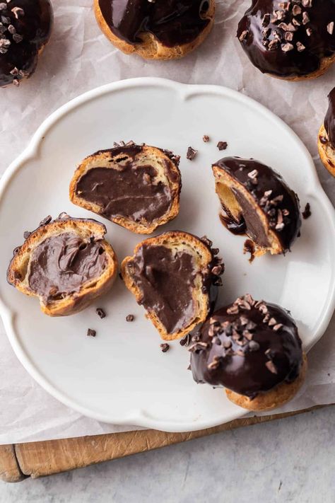 These Chocolate Cream Puffs are irresistible. Crisp choux pastry is filled with smooth, rich chocolate pastry cream and dunked in a delicious chocolate ganache. They make for an incredible dessert. Chocolate Cream Puffs, Chocolate Pastry Cream, Filling For Cakes, Chocolate Filling For Cake, French Custard, Choux Cream, Pastry Cream Recipe, French Baking, Cakes Pastries