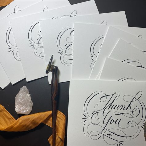 Lovingly laid out photo of hand drawn Thank you cards with calligraphy pen, quartz crystal and rust colored silk ribbon. Mirror Seating Chart, Wood Menu, Calligraphy Thank You, English Calligraphy, Calligraphy Stationery, Hand Calligraphy, Simple Artwork, Table Number Cards, Business Minded