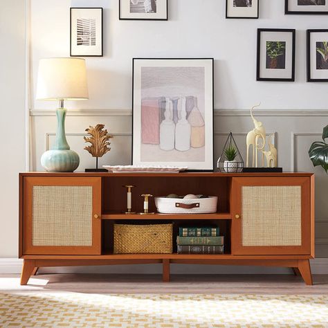 This TV cabinet blends the breezy boho-chic vibe with the timeless aesthetic of the mid-century modern design, resulting in a sleek and elegant appearance. The natural rattan embellishments add a touch of nature to your home, creating a tranquil and carefree display that exudes warmth. Each TV cabinet features handwoven natural rattan by skilled artisans, making each piece one-of-a-kind. Rattan Tv Console, Console Tv Stand, Rattan Door, 65 Inch Tv, Wood Media Console, Modern Entertainment Center, Console Tv, Timeless Aesthetic, Tv Stands And Entertainment Centers