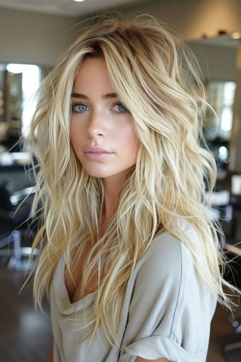 Woman with tousled blonde hair and blue eyes in a salon setting. Choppy Long Layers Haircut, Long Layered Textured Haircut, Messy Long Hair Styles, Beach Babe Hair, Long Choppy Layered Haircuts, Fall Blonde Long Hair, Long Hair With Shaggy Layers, Long Blonde Haircut Ideas, Choppy Long Haircut