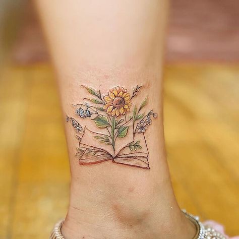 22 Cool Book Tattoo Ideas for Women - Mom's Got the Stuff Whimsical Flower Tattoos For Women, Wishie Tattoo, Book Tattoo Wrist, Wrist Book Tattoos, Book Tattoo Ideas For Women, Small Book Tattoo, Open Book Tattoo, Alzheimers Tattoo, Bookworm Tattoo