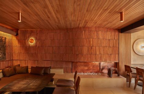 Lorenzo Botero and Martín Mendoza wrap Bogotá restaurant in brick Curved Fireplace, Wooden Table And Chairs, Earthy Colours, Natural Palette, Stone Bench, Storey Homes, Organic Wood, Brickwork, Wooden Chair