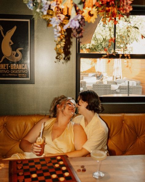 When it comes to local engagement sessions, I’ve got all the spots. 😍 these two are SUCH A DREAM. More of their sesh coming soon but I am in love with the shots we captured in their favorite bar @moshouse812 which is a woman owned biz who loudly and proudly supports our queer community here in Evansville. I can’t wait to photograph these two at their wedding next year. From proposals to engagement then to wedding day, seeing my couples through their whole commitment process is my favorite. ... Queer Engagement Photos, Greenhouse Bar, Nonbinary People, Videography Wedding, Queer Weddings, Drawing Body Poses, Maybe Someday, 2025 Vision, Body Poses