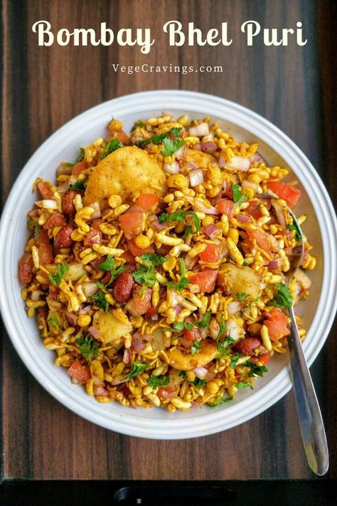 Bhel Puri is a popular Indian snack made with puffed rice, vegetables like boiled potatoes, tomatoes & onions, flavored with tangy chutneys. Bhel Puri Recipe, Bhel Recipe, Chats Recipe, Potatoes Tomatoes, Puri Recipe, Indian Veg Recipes, Veg Snacks, Puri Recipes, Spicy Snacks Recipes