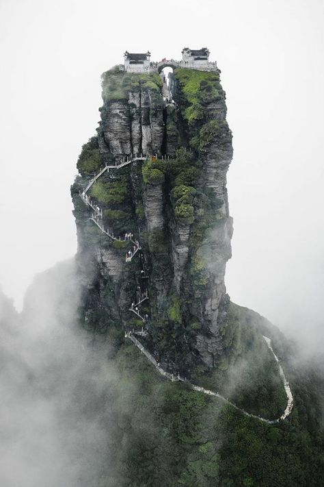 Fanjingshan is the highest peak in China’s Wuling Mountains and is a sacred place in Chinese Buddhism. This place of enlightenment includes New Golden Summit, where two Buddhist temples are perched high in the sky. Chinese Mountains, Chinese Landscape, Chinese Architecture, Buddhist Temple, Sacred Places, Fantasy Art Landscapes, China Travel, Fantasy Landscape, The Clouds