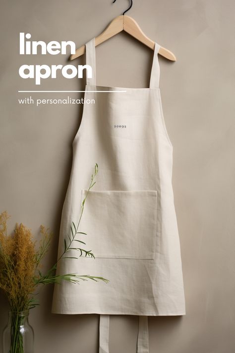 A minimalist linen apron is the perfect addition to any kitchen. It offers a clean and simple design that is both functional and stylish. Made from high-quality linen, this apron is lightweight and breathable, making it comfortable to wear for long periods of time. The neutral color and minimalistic design make it a versatile piece that can be worn by both men and women. Whether you're cooking up a storm or hosting a dinner party, this linen apron is a must-have accessory. Celemek Masak, Cafe Apron, Apron Kitchen, Marketing Photos, Promo Gifts, Natural Linen Fabric, Kitchen Apron, Long Periods, Minimalistic Design