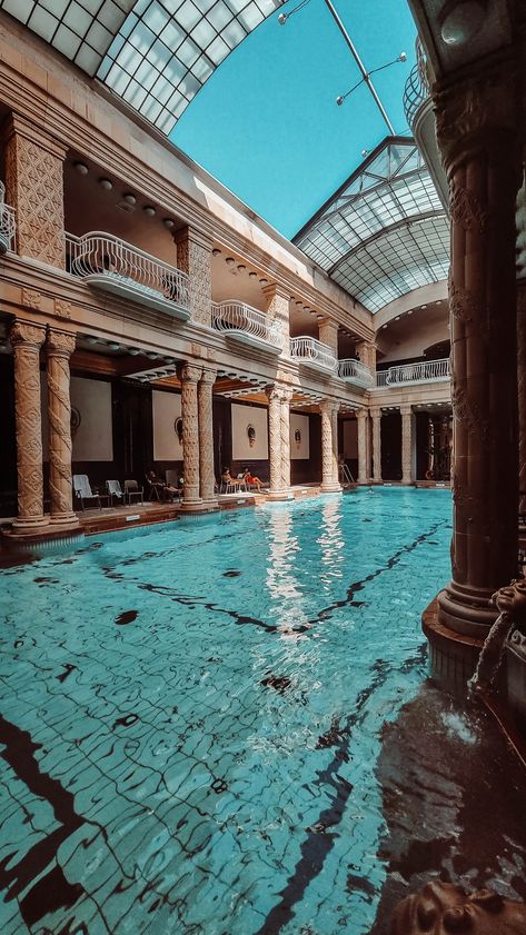 Semi outdoor pool with beautiful clear blue water and antic columns. Gellert Thermal Bath Budapest, Budapest Baths, Budapest Vacation, Budapest Thermal Baths, Bath Aesthetic, Visit Budapest, Thermal Baths, Thermal Pool, Outdoor Baths