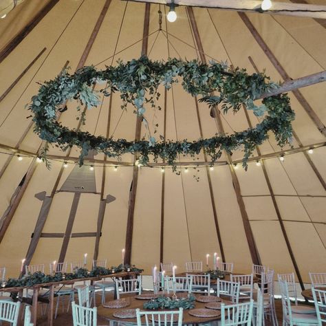 Giant floral installation 🌿 Look at this huge hoop - it's larger than the table it's sitting over! This is a pretty impressive statement! Designed by @makebelieveevents this soft eucalyptus and foliage feature enhances the rustic feel of the style and shows off the beams from the large tipis. This should give you inspiration about what can be done with this space. Speak to the team about hanging something similar, or other options like their paper lanterns or disco balls. What would you pre... Floral Installation, Disco Balls, Paper Lanterns, Rustic Feel, Beams, Lanterns, Floral, Quick Saves