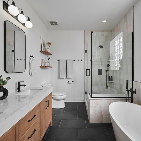 We transformed this bathroom into a bright, airy retreat: opened up with vertical tiles, a stunning freestanding tub, and sleek contemporary touches. Design & Remodel: @123remodeling Photo: @jambajim8 #interiordesign #bathroom #bathroomdesign #renovation #shower #homedecor Black Tile Bathroom Floor, Black Tile Bathrooms, Black Floor Tiles, Modern Bathroom Remodel, Dark Floors, Design Remodel, Freestanding Tub, Black Tiles, Black Floor