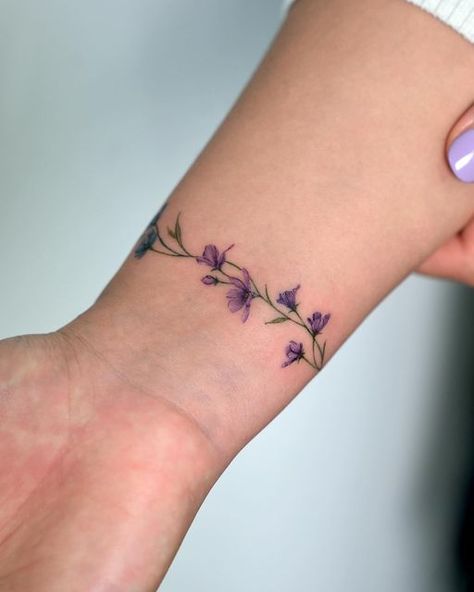 Morning Glory Arm Band Tattoo, Wrapped Flower Ankle Tattoo, Wrap Around Thumb Tattoo, Wrap Around Bracelet Tattoo, Violet Bracelet Tattoo, Wildflower Armband Tattoo, Forget Me Not Wrap Around Tattoo, Ivy Bracelet Tattoo, Flower Wrist Tattoos For Women Bracelet