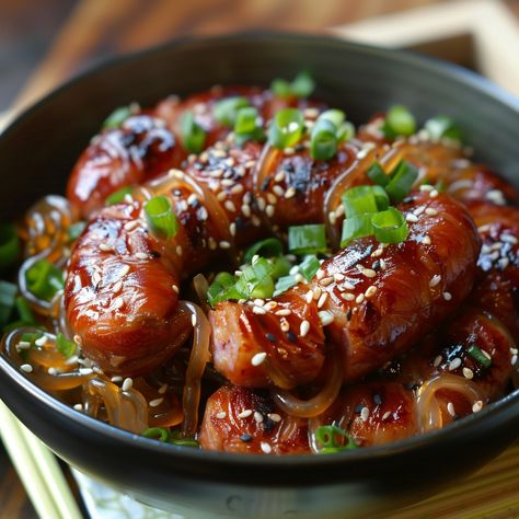 🌭 Try the unique taste of Korean Sundae! 🌭 #KoreanSausage #UniqueEats Sundae (Korean Sausage) Ingredients: Pork intestines (1 lb, cleaned) Sweet rice (1 cup, cooked) Cellophane noodles (1 cup, cooked and chopped) Green onions (1/2 cup, chopped) Garlic (2 cloves, minced) Salt (1 tsp) Black pepper (1/2 tsp) Sesame oil (1 tbsp) Instructions: Mix cooked rice, noodles, green onions, garlic, salt, pepper, and sesame oil. Stuff the mixture into cleaned pork intestines. Steam for 30-40 minutes un... Korean Sundae, Black Rice Noodles Recipe, Korean Sausage, Cellophane Noodles, Rice Noodle Recipes, Sausage Ingredients, Sweet Rice, Instagram Recipes, Twisted Recipes