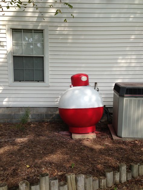 Finished product. Propane tank painted to look like a bobber. Lp Tank Painted, Large Propane Tank Art, Pond Crafts, Propane Tank Art, Propane Tank Cover, Lp Tank, Pig Painting, Pond Landscaping, Pumpkin Carving Templates