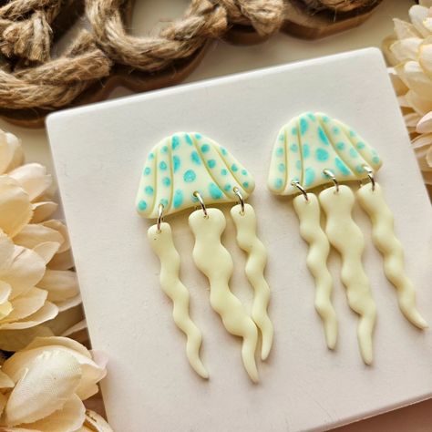 Did you see our new jellyfish earrings?! They glow in the dark! (SWIPE to the last photo to see the effect) I would definitely wear these to music festival! If I were still going to musical festivals 😅 Find these beauties in our shops! #8thandroseco #jellyfishearrings #glowinthedark #summercollection #smallbusinessowners #madeintennessee Ceramic Jellyfish, Clay Business, Jellyfish Earrings, Fish Earrings, Ceramic Fish, Pottery Crafts, Manualidades Diy, Polymer Clay Crafts, Diy Earrings