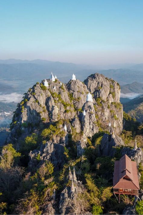 A breathtaking place with a meaningful story behind its existence, Wat Chaloem is a temple made of floating pagodas on top of a mountain, located in Lampang, Northern Thailand. Read my blog post on how to get there and avoid crowds | Be My Travel Muse | Northern Thailand travel tips | thailand road trips | Thailand off the beaten path Thailand Activities, Thailand Destinations, Koh Samui Beach, On Top Of A Mountain, Thailand Adventure, Thailand Backpacking, Top Of A Mountain, Thailand Travel Tips, Album Tutorial