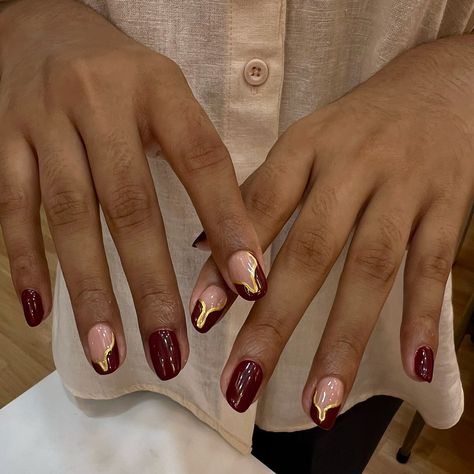 Nails as rich as fine wine, with a touch of gold. 🍷💛 To book your appointment: 🤳Call or WhatsApp at +98670 78427 OR 👩🏻‍💻Book Online 🏷️-red nails, burgundy nails, burgundy wine nails, burgundy and gold nails, nail art, nail extensions, nail goals #AtThePod #TheSugarPod #NaviMumbai #nailartclub #nailgoals #nailextensions #acrylicnails #burgundynails #burgundyandgoldnails #naildesigns #nailartinspo #nailsoftheday Cherry Red Nails With Gold Accents, Burgundy Gold Nail Designs, Nails Burgundy And Gold, Gold And Burgundy Nails, Burgundy Gold Nails, Wine And Gold Nails, Gold Burgundy Nails, Burgundy Nails With Gold, Burgundy And Gold Nails