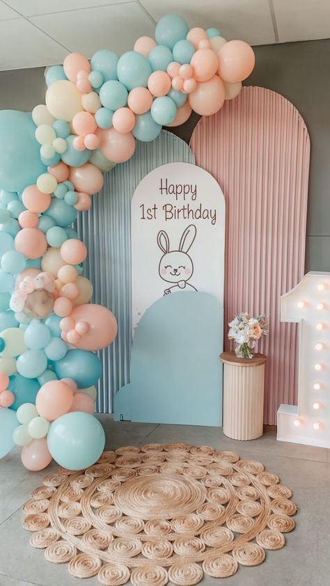 Adorable bunny-themed first birthday setup with pastel balloon garland, a "Happy 1st Birthday" sign featuring a bunny illustration, and soft pink and blue decor, creating a sweet and inviting atmosphere. 1st Birthday Theme, Party Ideas For Girls, First Birthday Party Ideas, 1st Birthday Signs, 1st Birthday Themes, Pastel Balloons, First Birthday Themes, Happy 1st Birthdays, Birthday Themes