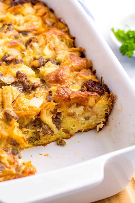 This easy sausage croissant breakfast casserole is the perfect make ahead meal. The flakey croissants, hearty sausages, and delicious cheese are a winning combination. Cheesy Sausage-and-croissant Casserole Southern Living, Sausage Crossaint Casserole, Croissants Breakfast Casserole, Cheesy Sausage And Croissant Casserole, Breakfast Casserole With Croissants And Sausage, Sausage Egg Cheese Croissant Casserole, Easy Breakfast Casserole With Croissants, Sausage Egg Croissant Casserole, Croissant Roll Breakfast Casserole