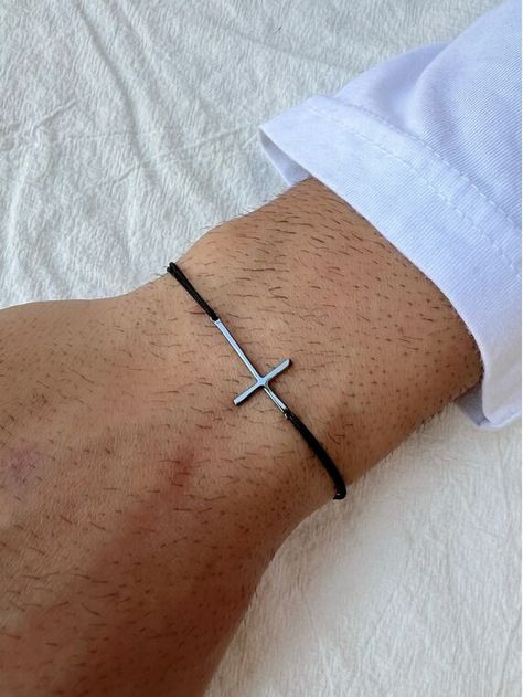 A Handmade Cross Bracelet for Men with a Black cross that is made from sterling silver 925. The Cross charm is passed through a black adjustable cross that fits in every hand from 15 to 23 cm wrist. Find them only at Christina Christi Store. Cross Bracelet For Men, Mens Cross Bracelet, Men's Bracelets, Types Of Gifts, Mens Crosses, Bracelet Men, Black Cross, Cord Bracelet, Minimalist Bracelet