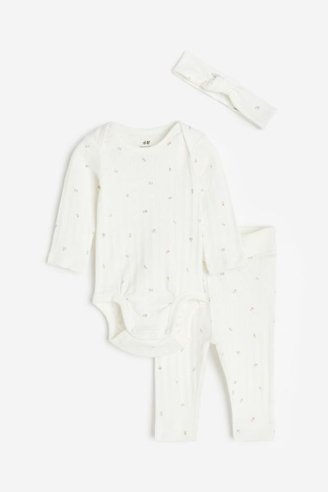 Set in supersoft cotton jersey with a bodysuit, pants, and an accessory. Long-sleeved bodysuit with a round neckline, snap fasteners at bottom for easy changing, and gathered seam around leg openings for added comfort and improved fit over diaper. Pants with a foldover waistband panel and cuffs.