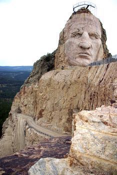 CRAZY HORSE MEMORIAL in progress. The 563-foot-high mountain carving-in-the-round will dominate the horizon. poem by Korczak will be carved on the mountain in letters three feet tall. The 350-foot diameter, hogan-style Indian Museum of North America will be across the reflecting pool from the mountain.The American Indian University Medical Training Center will rise on either side of the Avenue of the Chiefs. Aavenue will be lined with sculptural portraits of Natives Crazy Horse Monument, Crazy Horse Memorial, Indian Museum, Horse Memorial, Native American Wisdom, Western Comics, Medical Training, The Chiefs, High Mountain