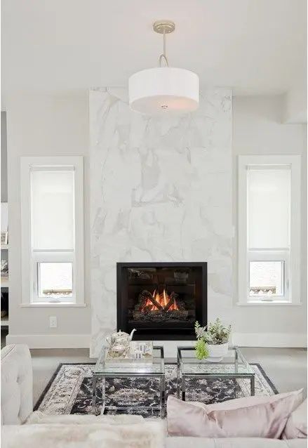 a glam white living room with a white marble fireplace, neutral seating furniture, coffee tables and some decor No Mantle Fireplace Ideas, Fireplace With No Mantle, Mod Fireplace, Renovation Fireplace, Tiled Fireplaces, Fireplace Design Ideas, Contemporary Fireplace Designs, Fireplace Designs, Shiplap Fireplace